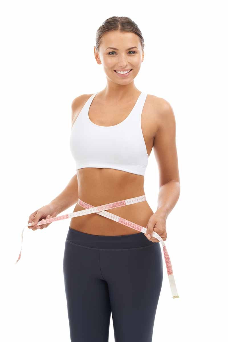 A woman in athletic wear measuring her waist — semaglutide weight loss in McAllen, TX